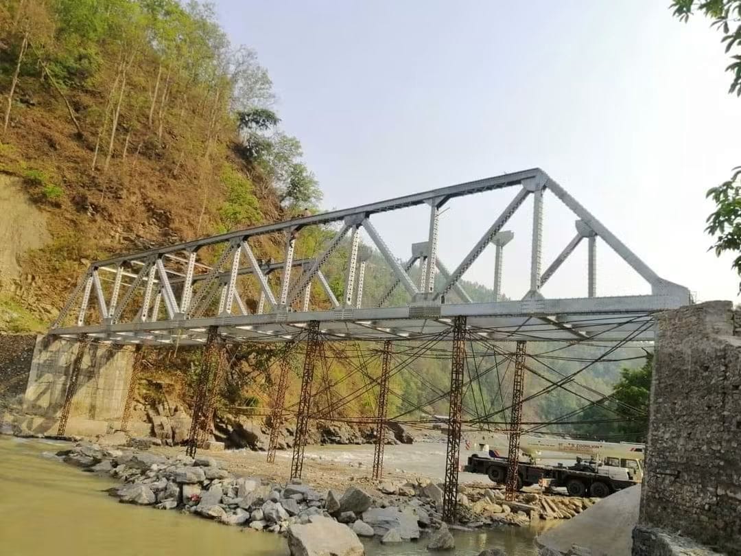 Steel bridge assembly across a river